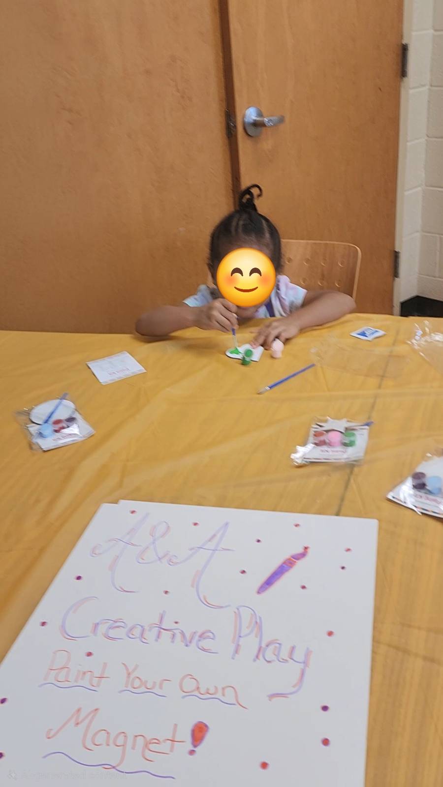 Birthday party guest painting their own magnet