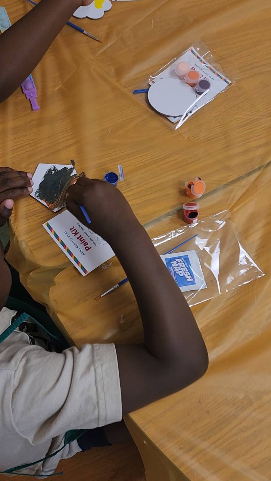 Birthday party guest painting their own magnet
