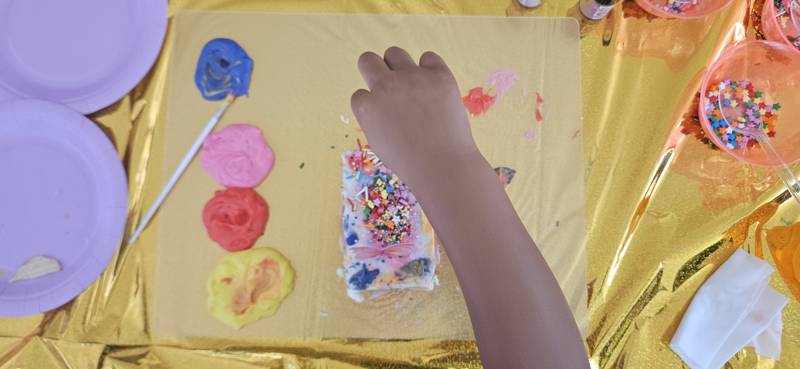 Cake decorating - painted cake close up with sprinkles
