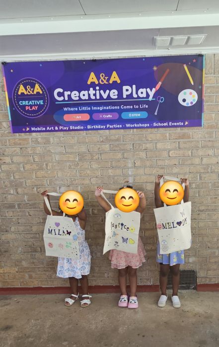Kids holding their finished personalized tote bags