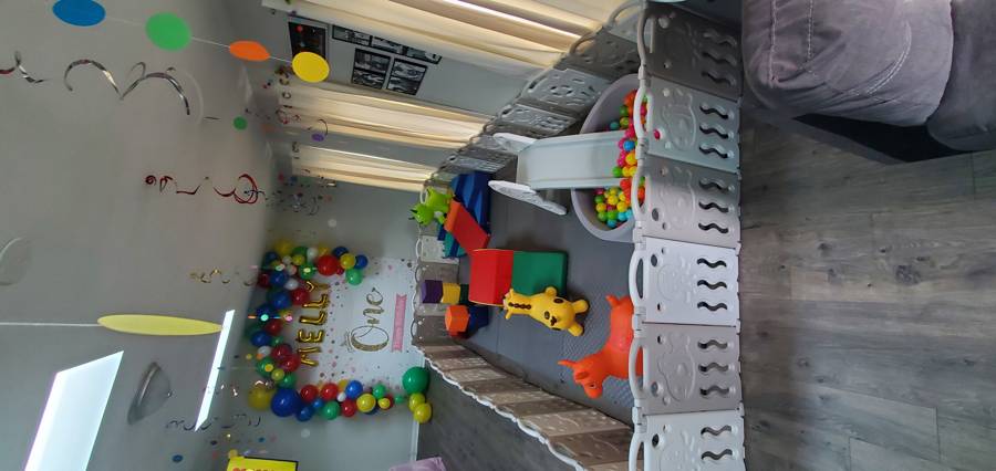 Soft play setup with ball pit, slide, and foam shapes for a birthday party